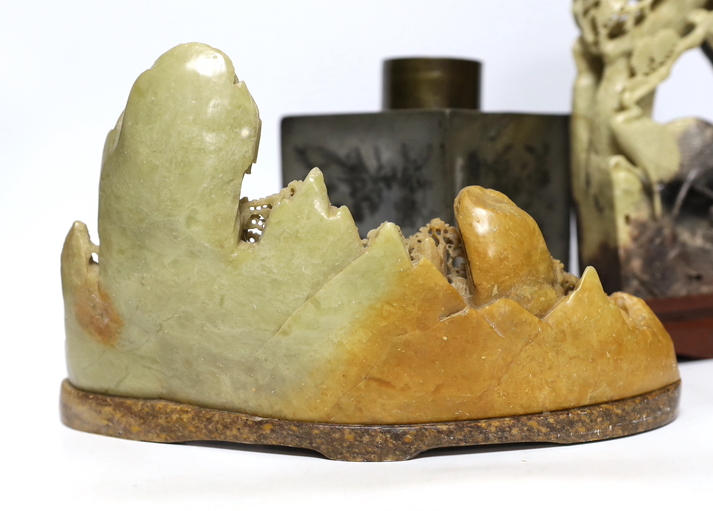 Two Chinese soapstone carvings and a pewter tea canister decorated with birds, largest 24cm high